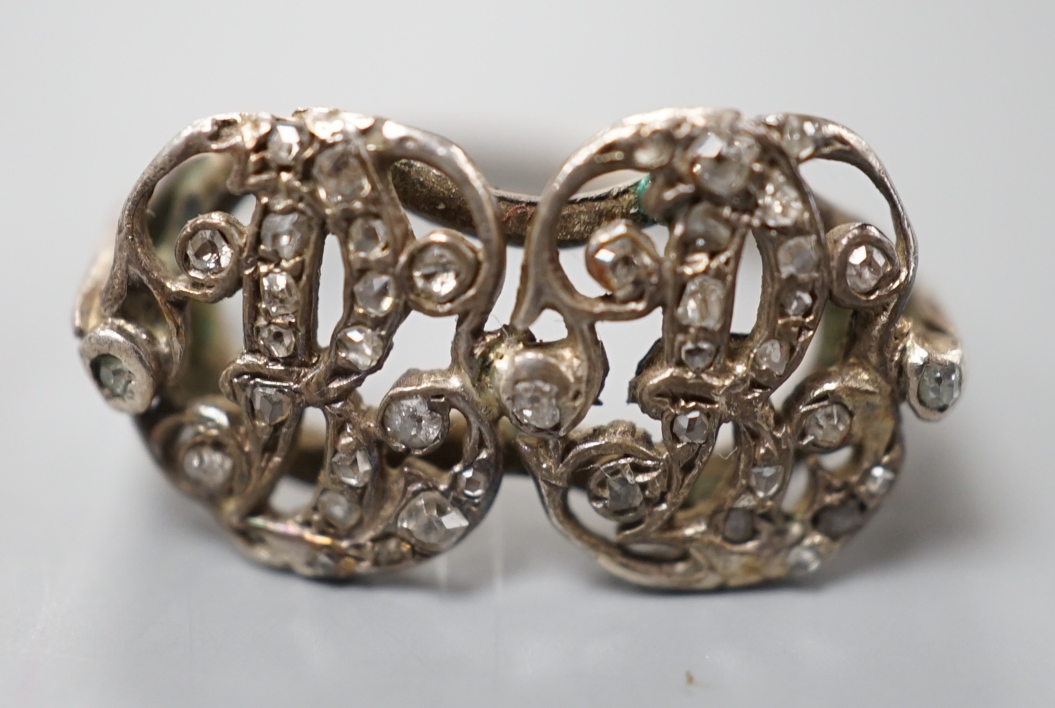A 19th century white metal and rose cut diamond chip set monogram? ring, size L, gross weight 3 grams.